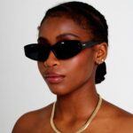 Black Female Model wearing Faith Sunglasses, luxurious rectangle sunglasses by AKA SAVRAN