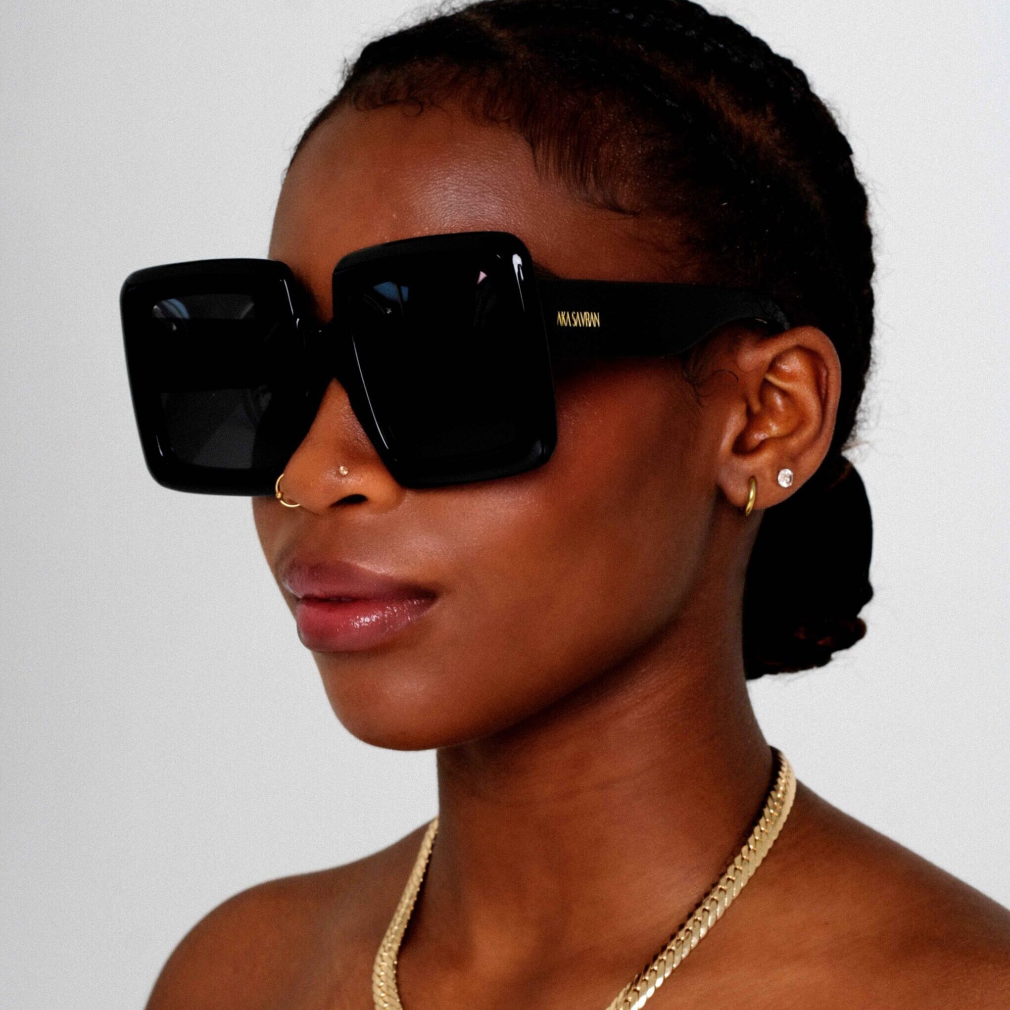 Black Female model wearing Lunaire Oversized Sunglasses, Black acetate Sunglasses by AKA SAVRAN
