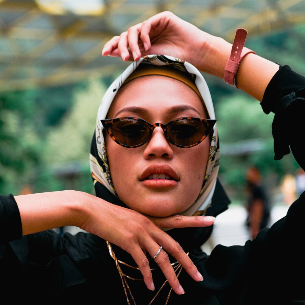 attractive arab woman with silk hijab/headwrap wearing sunglasses which fits her round face shape