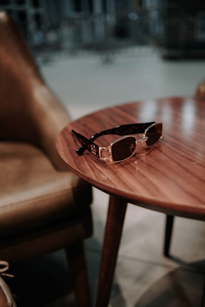 Image of luxury designer sunglasses on a luxurious wooden table