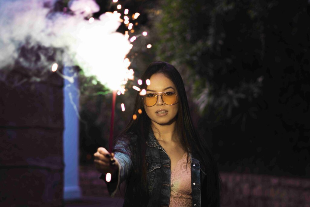 Asian woman with Asian fit luxury sunglasses celebrating in a casual outfit