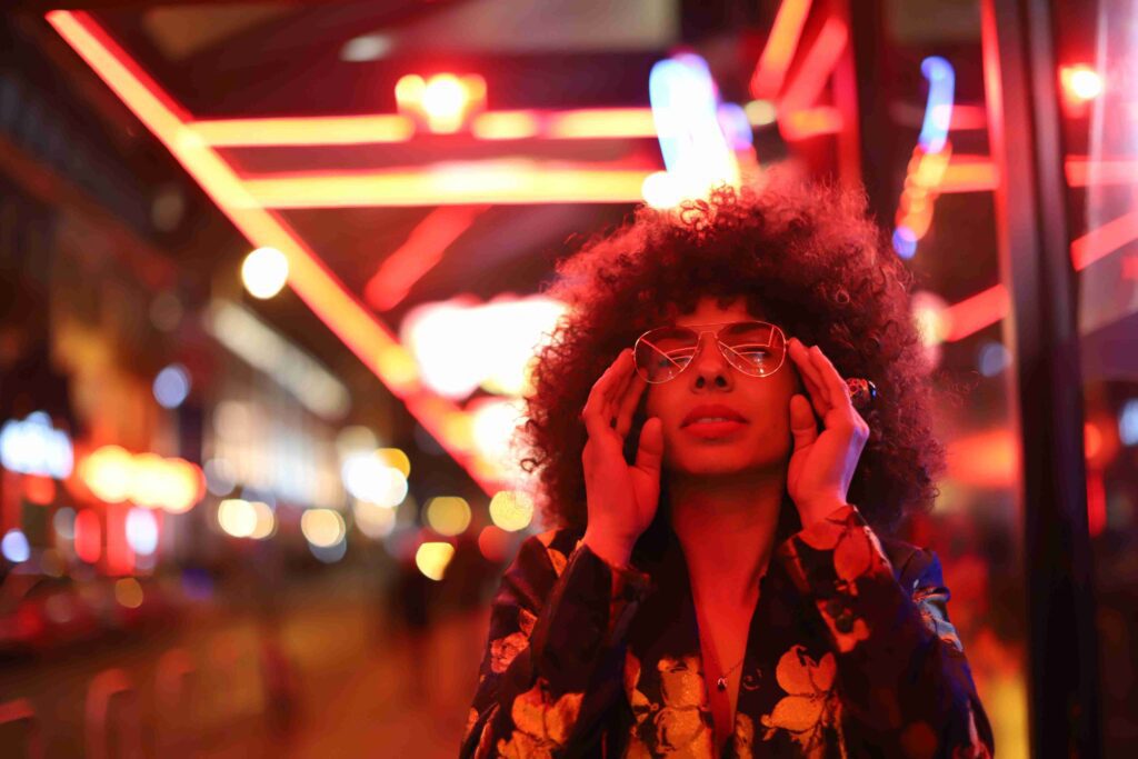 Mixed Woman with sunglasses on her date night in a beautifully lit area