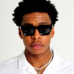 Black Male Model wearing Rebel, luxurious square sunglasses by AKA SAVRAN, inspired by Virgil Abloh