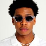 Black male model wearing Rebel Transparent, luxurious square sunglasses by AKA SAVRAN, inspired by Virgil Abloh and made out of acetate