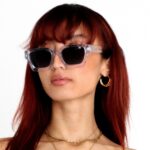 Asian female model wearing Rebel Transparent, luxurious square sunglasses by AKA SAVRAN, inspired by Virgil Abloh and made out of acetate
